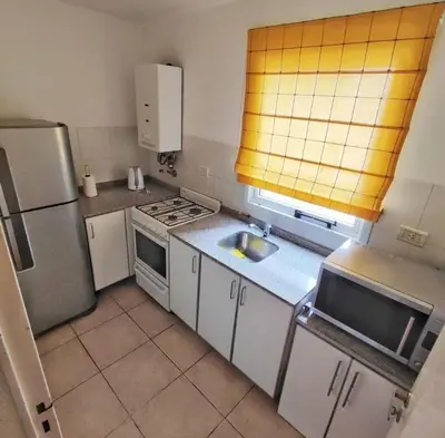 a small kitchen with a sink and a refrigerator at Departamento en calle Independencia in Cordoba