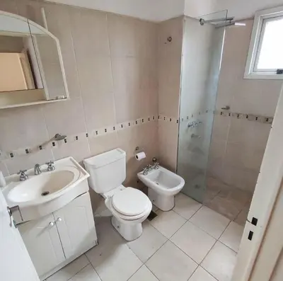 a bathroom with a toilet and a sink and a shower at Departamento en calle Independencia in Cordoba