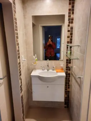 a man taking a picture of a bathroom with a sink at Terra Zion in Cordoba