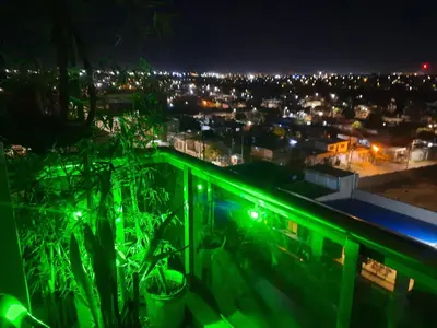 a view of a city at night with green lights at Terra Zion in Cordoba