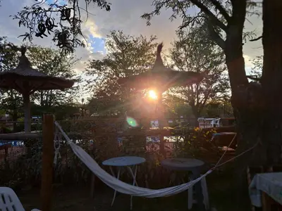 a hammock with the sun setting in the background at complejo inti sumah in Nono