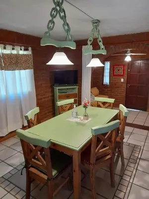 a kitchen with a dining room table and chairs at complejo inti sumah in Nono