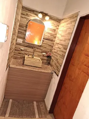a bathroom with a sink and a mirror at complejo inti sumah in Nono