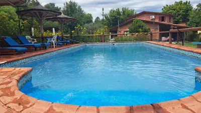 a large swimming pool with blue water in a yard at complejo inti sumah in Nono