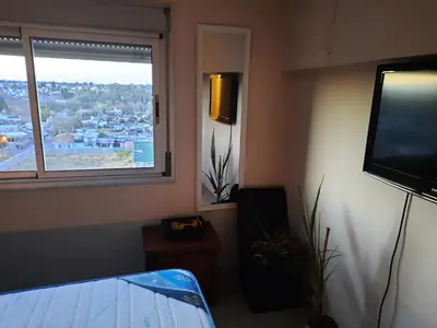 a living room with a tv and a window at Terra Zión in Cordoba