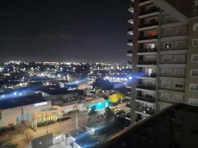 a view of a city at night from a building at Terra Zión in Cordoba