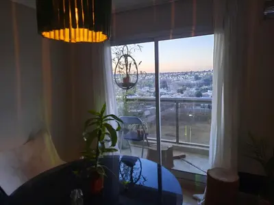 a living room with a table and a large window at Terra Zión in Cordoba
