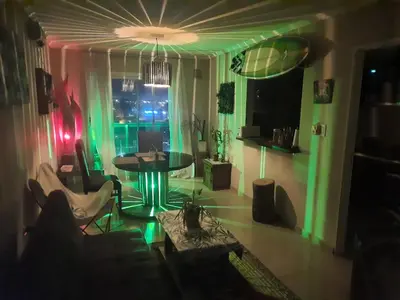 a living room with a table and green lighting at Terra Zión in Cordoba