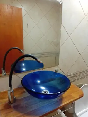 a blue sink with a faucet in a bathroom at Monoambiente Amoblado in Cordoba