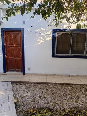 a house with a door and a window and a sidewalk at Monoambiente Amoblado in Cordoba