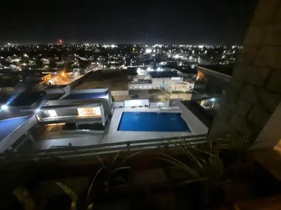 a view of a building with a swimming pool at night at Terra Zión in Cordoba