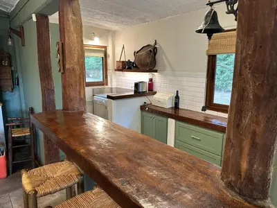 a kitchen with a wooden counter top in a room at Casa de campo con piscina, limpieza y desayuno in Río Cuarto