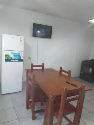 a kitchen with a wooden table and a refrigerator at Departamento luna in Cordoba