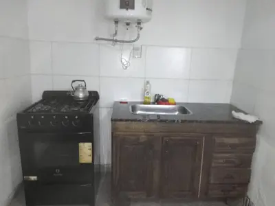 a small kitchen with a stove and a sink at Departamento luna in Cordoba