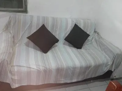 a couch with two pillows on it in a room at Departamento luna in Cordoba