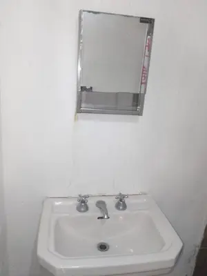 a white bathroom sink with a mirror on the wall at Departamento luna in Cordoba