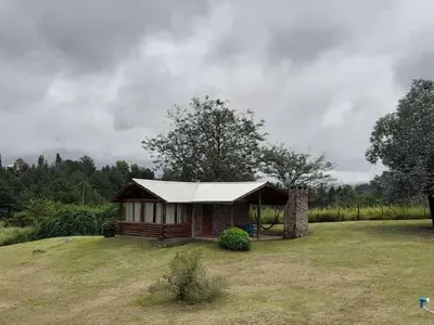 a small cabin on top of a grass field at Cabañas Alma de Montaña