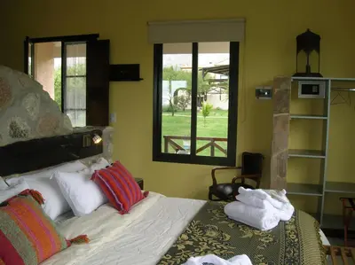 a bedroom with a bed with towels on it at Apart Los Antiguos in Merlo