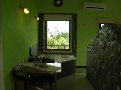a green bathroom with a sink and a window at Apart Los Antiguos in Merlo