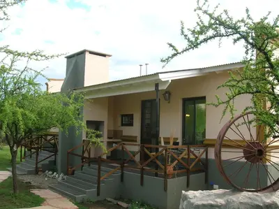 a house with a large wheel in front of it at Apart Los Antiguos in Merlo