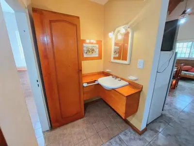 a small bathroom with a sink and a counter at Complejo Lago Chico in Tanti
