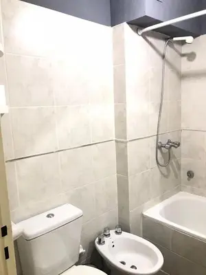 a bathroom with a toilet and a sink and a tub at Pueyrredon045 in Cordoba