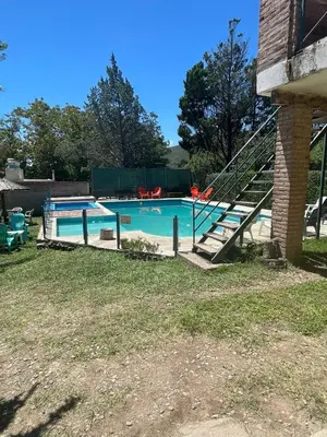 a swimming pool with a slide in a yard at Santa Rosa Cabañas in Santa Rosa de Calamuchita
