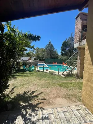 a view of a swimming pool from a yard at Santa Rosa Cabañas in Santa Rosa de Calamuchita