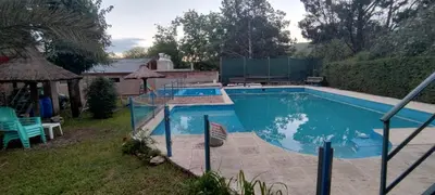 a large swimming pool in a yard with at Santa Rosa Cabañas in Santa Rosa de Calamuchita
