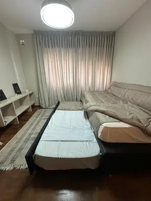 a bedroom with two beds and a window at Moderno mono ambiente in Cordoba