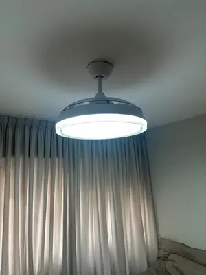 a light hanging from a ceiling in front of a curtain at Moderno mono ambiente in Cordoba