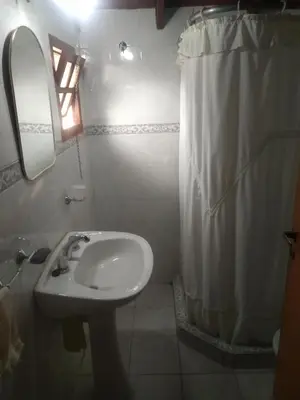 a bathroom with a sink and a shower curtain at Los abuelos in Santa Rosa de Calamuchita