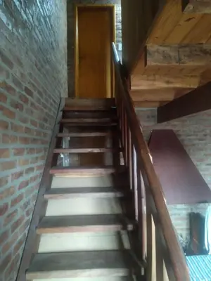 a set of stairs in a building with a door at Los abuelos in Santa Rosa de Calamuchita