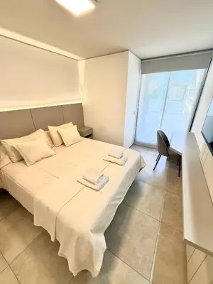 a bedroom with a bed with two towels on it at Petit Premium Nueva Cba - Oulton in Cordoba