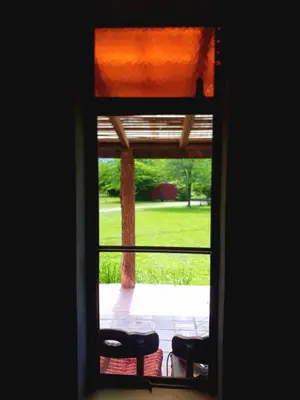 a view through a window of a yard at Puesto Potrillos in Villa Yacanto