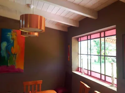 a chandelier in a dining room with a window at Puesto Potrillos in Villa Yacanto
