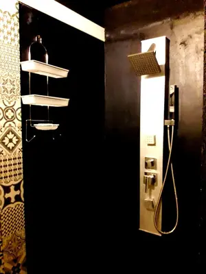 a bathroom with a shower with a shelf and a mirror at Puesto Potrillos in Villa Yacanto