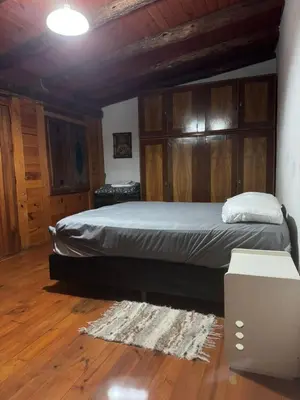 a bedroom with a bed and a wooden ceiling at La casa de Pedro in San Roque