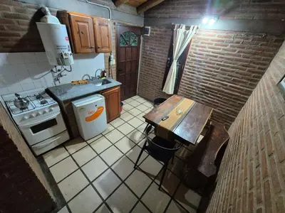 an overhead view of a kitchen with a table and stove at Cabañas Eduviges in Mina Clavero