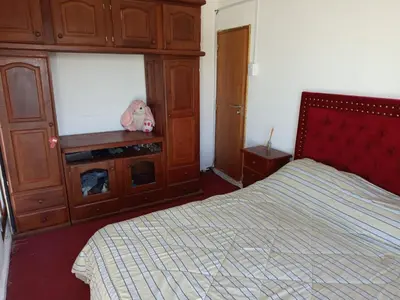 a bedroom with a bed and a cabinet with a stuffed animal at CABAÑA Casa Saavedra in Tanti