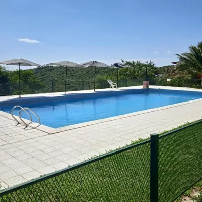 a large swimming pool with a fence around it at CABAÑA Casa Saavedra in Tanti
