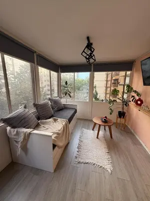 a bedroom with a bed and a table and windows at Apartmento completo en Nueva Córdoba Argentina in Cordoba