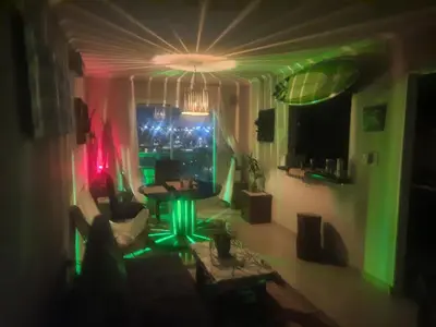 a living room with a green and red lighting at Terra Zión in Cordoba