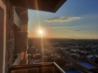 a view of the sunset from the balcony of a building at Terra Zión in Cordoba