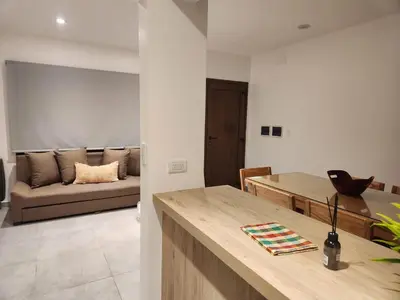 a kitchen and living room with a couch in the background at Departamento macrocentro II, espacioso Río Cuarto in Río Cuarto