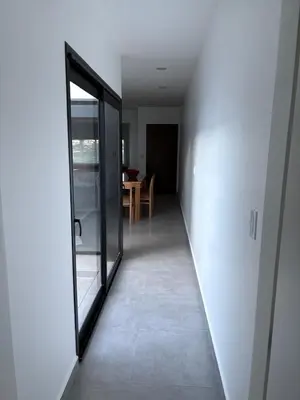 a hallway with a glass door and a dining room at Departamento macrocentro II, espacioso Río Cuarto in Río Cuarto