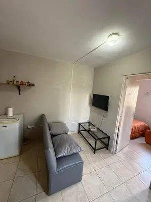 a living room with a couch and a television at Depto Maipu in Cordoba