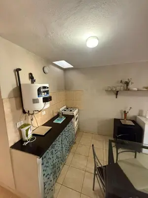 a kitchen with a stove and a counter top at Depto Maipu in Cordoba