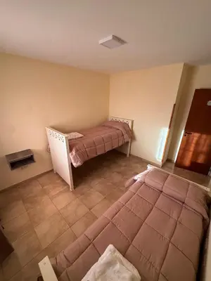 a bedroom with two beds in a room at Apart Dinkendein de 2 dormitorios in Río Cuarto