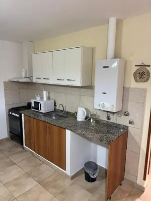 a kitchen with a counter top with a microwave at Apart Dinkendein de 2 dormitorios in Río Cuarto